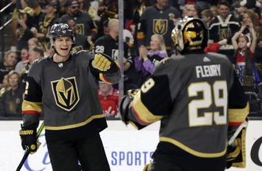 Vegas Golden Knights defenseman Nick Holden, Right, celebrates with goalie Marc-Andre Fleury after scoring against the Washington Capitals during the first period of an NHL hockey game Monday, Feb. 17, 2020, in Las Vegas. (AP Photo/Isaac Brekken)