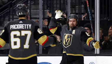 Golden Knights right wing Mark Stone, right, celebrates with left wing Max Pacioretty after scoring against the Tampa Bay Lightning during the second period of an NHL hockey game Thursday, Feb. 20, 2020, in Las Vegas. 