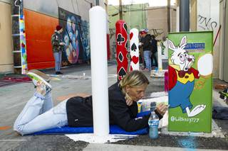 Artist Sissy Murphy paints during the unveiling of dT-Alley, a T-shaped alley dedicated to the arts and education located in downtown Las Vegas Wednesday, Feb. 19, 2020. (Las Vegas Sun, Yasmina Chavez)