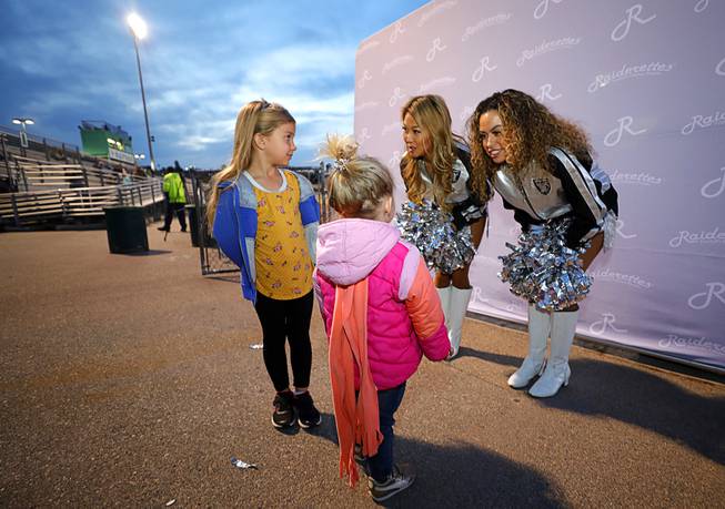 Zoe, 6, and Livvy, 2, Henderson chat with Raiderettes  the NIAA 4A State High School Girls Flag Football Championship at Green Valley High School in Henderson Thursday, Feb. 27, 2020. Zoe and Livvy's sister Hallie plays for Las Vegas High.