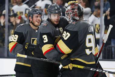 Vegas Golden Knights defenseman Nate Schmidt, left, defenseman Brayden McNabb (3) and Robin Lehner (90) celebrate after defeating the Buffalo Sabres in an NHL hockey game Friday, Feb. 28, 2020, in Las Vegas.