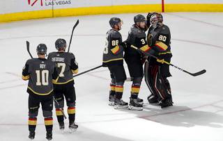 Vegas Golden Knights players celebrate with Vegas Golden Knights goaltender Robin Lehner (90) after their 4-2 victory over the Buffalo Sabres at T-Mobile Arena in Las Vegas Friday, Feb. 28, 2020. The Golden Knights defeated the Sabres 4-2.
