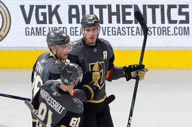 Vegas Golden Knights right wing Reilly Smith (19) is congratulated by Paul Stastny (26) and Jonathan Marchessault (81) after scoring an empty net goal, his second goal of the game, during the third period of an NHL hockey game against the Buffalo Sabres at T-Mobile Arena in Las Vegas Friday, Feb. 28, 2020.