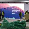 Workers dismantle a booth after that the 90th Geneva International Motor Show (GIMS) is canceled by Swiss authorities, at the Palexpo in Geneva, Switzerland, Friday, Feb. 28, 2020. The 90th edition of the International Motor Show, scheduled to begin on March 5th, is cancelled due to the advancement of the (Covid-19) coronavirus in Switzerland. The Swiss confederation announced today that all events involving more than 1,000 people would be banned until March 15.