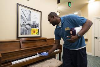 Dwayne Wade, Director of Environmental Services, uses disinfectant wipes to clean common areas in Poet's Walk Memory Care Assisted Living Community in Henderson, Wednesday, March 4, 2020.