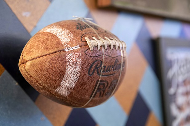 A football is displayed on a wall in the BetMGM sports book at the Park MGM Friday, March 6, 2020.