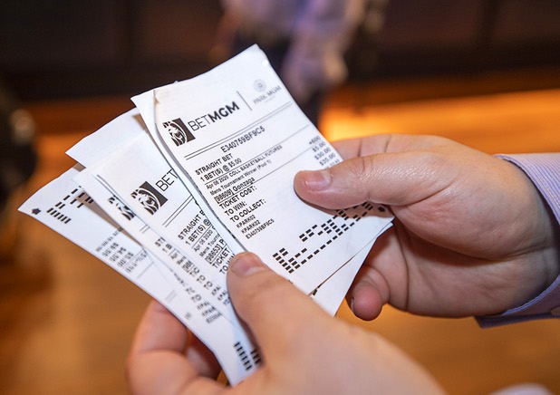 Ivan Souffront, a senior product manager for Roar Digital, displays betting slips from a self-service sports betting kiosk in the BetMGM sports book at the Park MGM Friday, March 6, 2020.