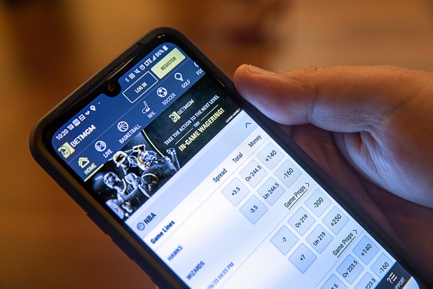 Ivan Souffront, a senior product manager for Roar Digital, displays the BetMGM mobile app on his phone in the BetMGM sports book at the Park MGM Friday, March 6, 2020.
