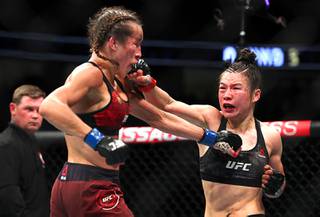UFC women's strawweight champion Weili Zhang, right, of China punches former champion Joanna Jedrzejczyk of Poland during UFC 248 at T-Mobile Arena in Las Vegas Saturday, March 7, 2020.