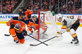 Edmonton Oilers' Darnell Nurse (25) and goaltender Mikko Koskinen (19) protect the net against Vegas Golden Knights' Nick Cousins (21) during first-period NHL hockey game action in Edmonton, Alberta, Monday, March 9, 2020.