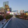 Pedestrians walk down a normally busy sidewalk along the Las Vegas Strip Sunday, March 15, 2020. 