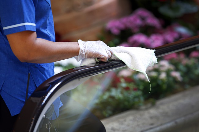 A worker sanitizes an escalator hand rail in the atrium area between the Palazzo and Venetian in Las Vegas,Tuesday, March 17, 2020.