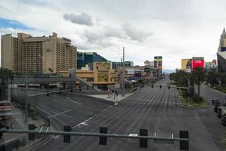 The intersection of Las Vegas Blvd and Harmon Ave is seen mostly empty after Governor Sisolak orders a mandatory closure of all nonessential businesses in an effort to combat the spread of COVID-19, Wednesday, March 18, 2020.