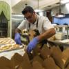 Chef Todd Harrington puts complimentary cookies in to-go orders at Honey Salt on March 19. The Summerlin-area restaurant has become the hub of the new Delivering With Dignity program.