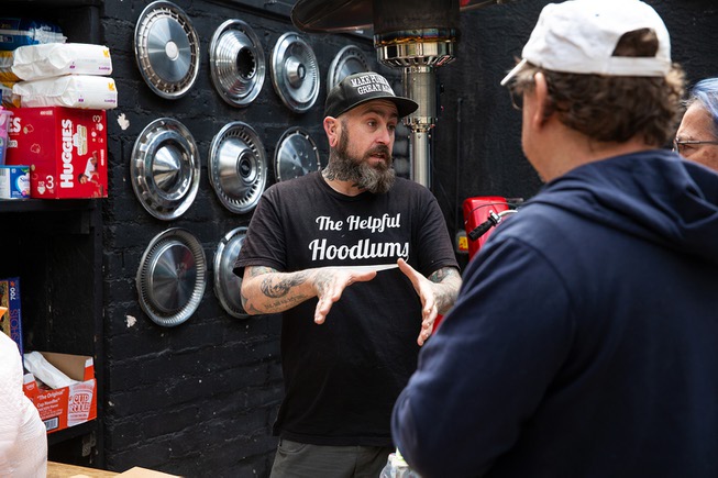 Dustin Hoots, founder of The Helpful Hoodlums, speaks with a ...