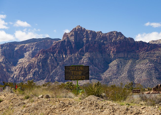 A sign indicates closure of the Red Rock Canyon scenic ...
