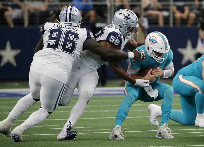 Dallas Cowboys' Maliek Collins (96) and Robert Quinn (58) sack Miami Dolphins quarterback Josh Rosen (3) in the second half of an NFL football game in Arlington, Texas, Sunday, Sept. 22, 2019. 