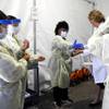 Doctors and health care workers with the UNLV School of Medicine suit up in personal protective equipment before taking patients at a drive-thru coronavirus testing site Tuesday, March 24, 2020, in Las Vegas. 