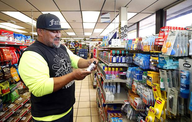 Customer Eddie Quintanilla looks over a bottle of hand sanitizer at the Stage Door Casino at Flamingo Road and Linq Lane Tuesday, March 31, 2020. The casino is closed but the market is still open.