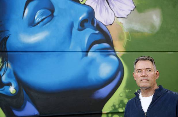 Robert Dornisch, a table games dealer at the Golden Nugget, pauses by a mural while taking a walk in downtown Las Vegas Tuesday, April 7, 2020.