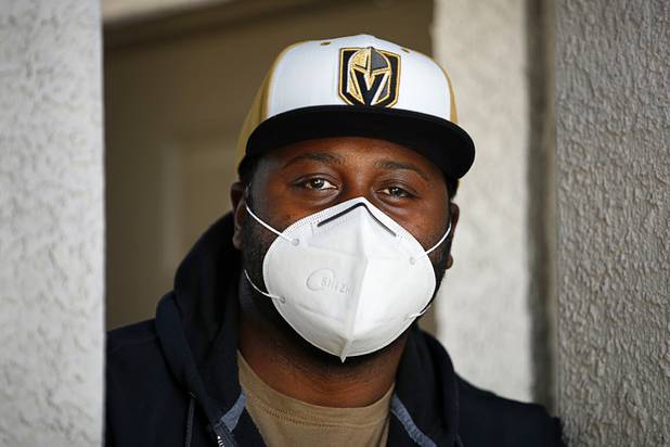 Nathaniel Manns, a bell captain at the Flamingo, poses outside his apartment in Henderson Wednesday, April 8, 2020.