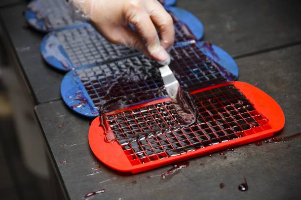 An employee makes cannabis infused hard candy known as canna-cubes at Evergreen Organix edibles production facility, Wednesday, Sept. 26, 2018.