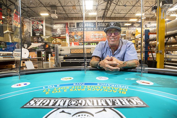 Owner James Swanson poses by a blackjack table with protective polycarbonate barriers at Screaming Images Thursday, May 7, 2020. The blackjack tables have received a lot of attention but the barriers have a variety of applications in business and office space.