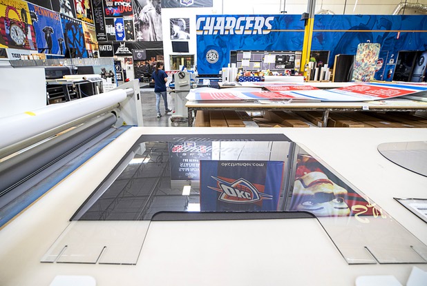 A protective polycarbonate barrier is shown on a table at Screaming Images Thursday, May 7, 2020. Screaming Images is a graphic design and installation firm.