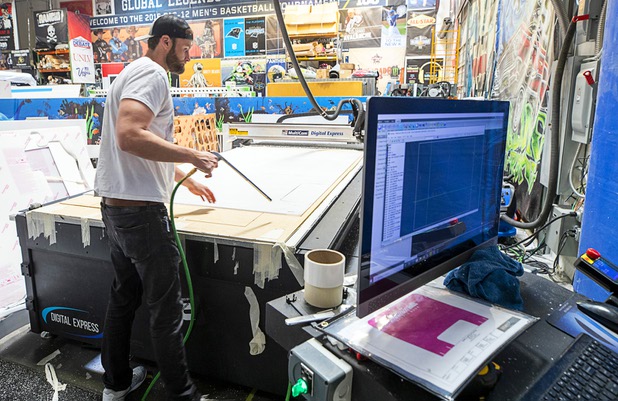 Sean Southam makes protective polycarbonate barrier at Screaming Images Thursday, May 7, 2020. The barriers have a variety of applications in gaming, business and office space.