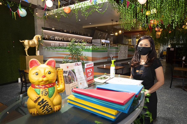 Server Jenny Prapasanobol waits for customers in the dining area of the Siam Square Thai Restaurant, 611 Fremont St., Saturday, May 9, 2020. Saturday was the first day restaurants, salons and other nonessential businesses were allowed to reopen after restrictions were imposed to help slow the spread of the new coronavirus.