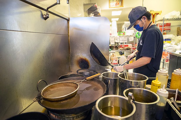 Owner Tao Namwichai makes an order of Pad Thai the Siam Square Thai Restaurant, 611 Fremont St., Saturday, May 9, 2020. Saturday was the first day restaurants, salons and other nonessential businesses were allowed to reopen after restrictions were imposed to help slow the spread of the new coronavirus.