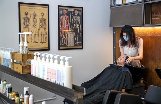 Jade Evans gets his hair shampooed by stylist Eden Walton at Makeshift Union, on California Avenue by Casino Center Boulevard Saturday, May 9, 2020. Saturday was the first day restaurants, salons and other nonessential businesses were allowed to reopen after restrictions were imposed to help slow the spread of the new coronavirus.