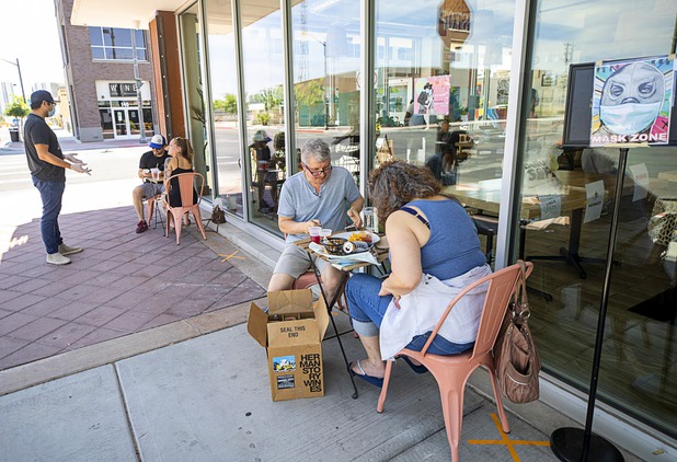 Dale and Jamie Lombardi have a meal on the sidewalk at Tacotarian, a plant-based Mexican restaurant at Casino Center Boulevard and California Avenue Saturday, May 9, 2020. The restaurant also offered dining in its patio. Saturday was the first day restaurants, salons and other nonessential businesses were allowed to reopen after restrictions were imposed to help slow the spread of the new coronavirus.