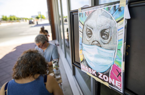 A sign designates a "mask zone" for sidewalk dining at Tacotarian, a plant-based Mexican restaurant at Casino Center Boulevard and California Avenue Saturday, May 9, 2020. Saturday was the first day restaurants, salons and other nonessential businesses were allowed to reopen after restrictions were imposed to help slow the spread of the new coronavirus.