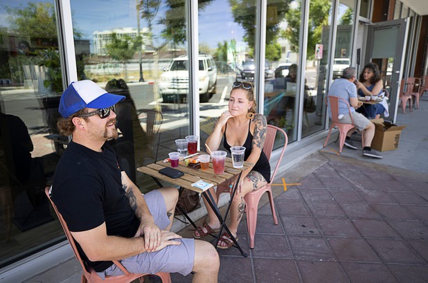 Patrick (no last name provided) and his girlfriend Leslie Sorenson dine at Tacotarian, a plant-based Mexican restaurant at Casino Center Boulevard and California Avenue Saturday, May 9, 2020. Saturday was the first day restaurants, salons and other nonessential businesses were allowed to reopen after restrictions were imposed to help slow the spread of the new coronavirus.