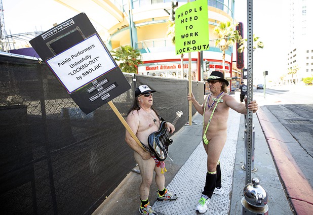 Entertainers Michael Troy, left, and 'Lucky Joe" Priotti protest in front of the Fremont Street Experience during an "Open Air Fremont Street March 2020" Saturday, May 9, 2020. Restaurants, salons and other nonessential businesses were allowed to reopen Saturday but the Fremont Street Experience remains closed.