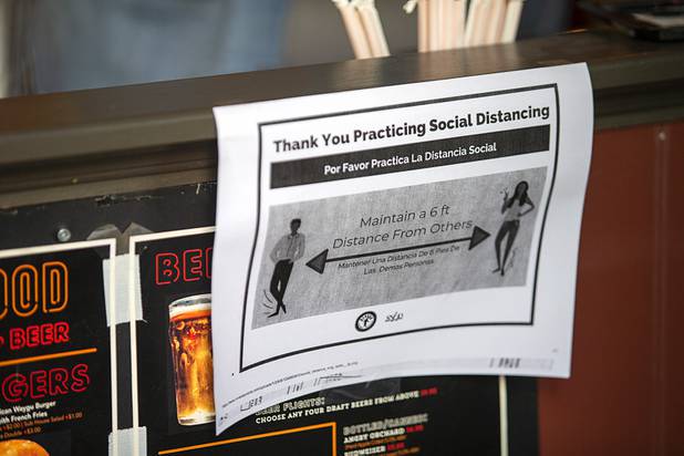 A sign at Flippin' Good Chicken, Burgers, Beer on East Fremont Street encourages social distancing Saturday, May 9, 2020. Saturday was the first day restaurants, salons and other nonessential businesses were allowed to reopen after restrictions were imposed to help slow the spread of the new coronavirus.