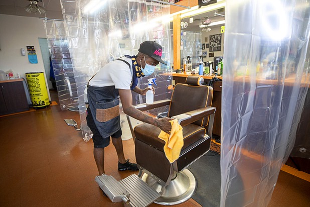 Barber Troy Jones sanitizes a chair after a haircut at A Cut Above The Rest barber shop, 616 Carson Ave., Saturday, May 9, 2020. The barber shop is open for business by appointment.