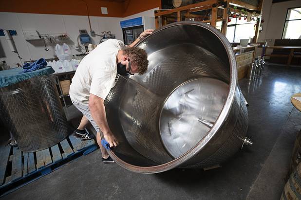 Distillery worker Will Wood cleans a 1,000 liter vat before mixing hand sanitizer at the Las Vegas Distillery in Henderson Wednesday, May 13, 2020. The distillery has switched from making distilled spirits to hand sanitizer in order to help in the fight against the novel coronavirus (COVID-19).