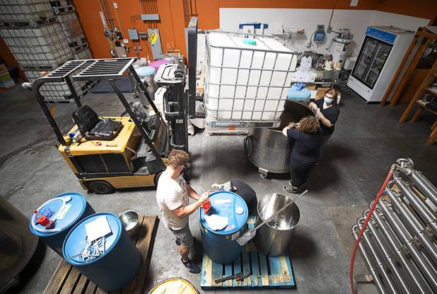 Distillery workers mix hand sanitizer at the Las Vegas Distillery in Henderson Wednesday, May 13, 2020. The distillery has switched from making distilled spirits to hand sanitizer in order to help in the fight against the novel coronavirus (COVID-19).