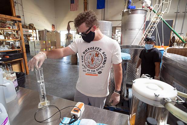 Will Wood uses a hydrometer to check the percentage of alcohol in hand sanitizer at the Las Vegas Distillery in Henderson Wednesday, May 13, 2020. The distillery has switched from making distilled spirits to hand sanitizer in order to help in the fight against the novel coronavirus (COVID-19).