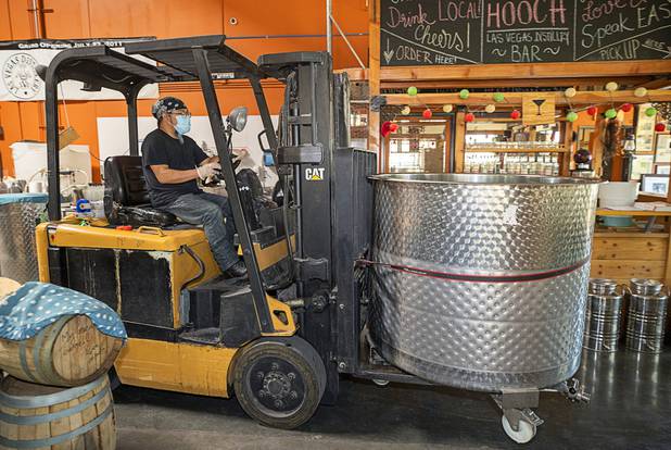 Julian Morales uses a fork lift to move a vat of hand sanitizer at the Las Vegas Distillery in Henderson Wednesday, May 13, 2020. The distillery has switched from making distilled spirits to hand sanitizer in order to help in the fight against the novel coronavirus (COVID-19).
