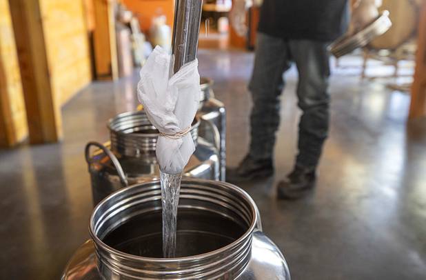 Hand sanitizer is transferred into smaller container prior to bottling at the Las Vegas Distillery in Henderson Wednesday, May 13, 2020. The distillery has switched from making distilled spirits to hand sanitizer in order to help in the fight against the novel coronavirus (COVID-19).
