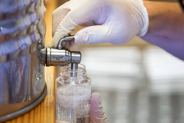 Will Wood bottles hand sanitizer at the Las Vegas Distillery in Henderson Wednesday, May 13, 2020. The distillery has switched from making distilled spirits to hand sanitizer in order to help in the fight against the novel coronavirus (COVID-19).