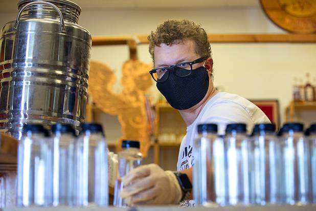 Will Wood bottles hand sanitizer at the Las Vegas Distillery in Henderson Wednesday, May 13, 2020. The distillery has switched from making distilled spirits to hand sanitizer in order to help in the fight against the novel coronavirus (COVID-19).