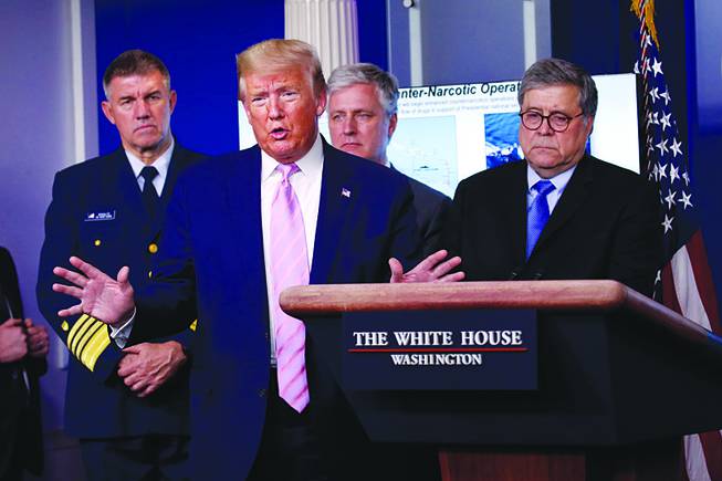 Trump speaks April 1 during a news conference at the White House as Adm. Karl Leo Schultz, commandant of the Coast Guard, national security adviser Robert O’Brien and Attorney General William Barr listen. More than any other modern-era attorney general, critics contend, Barr has enabled the president to use the Justice Department for his own purposes.