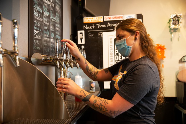 Beertender Chelsea Anderson pours a beer at CraftHaus Tap Room ...