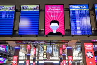 A display encouraging the wearing of face masks is displayed in the baggage claim area at McCarran International Airport Wednesday, May 20, 2020. On Wednesday, the airport launched 
