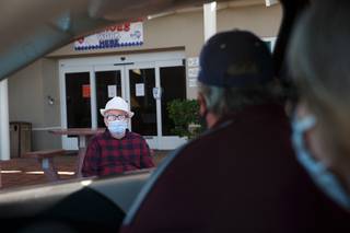 Scott Davis talks to his father Richard Davis, a resident at the Nevada State Veterans Home in Boulder City Nevada, Saturday May 16, 2020. The nursing home allows visits under strict social distancing guidelines during the COVID-19 pandemic.