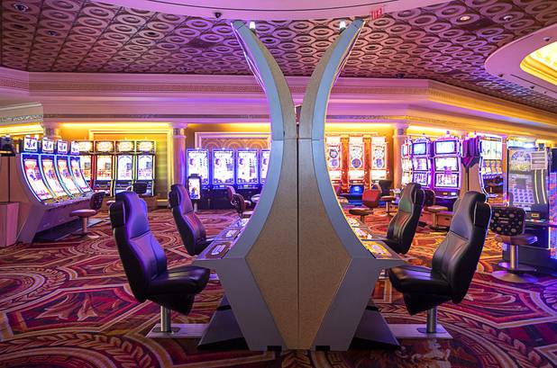 Slot machines, with chairs removed for social distancing, are shown on the casino floor during a tour of Caesars Palace Thursday, May 21, 2020.